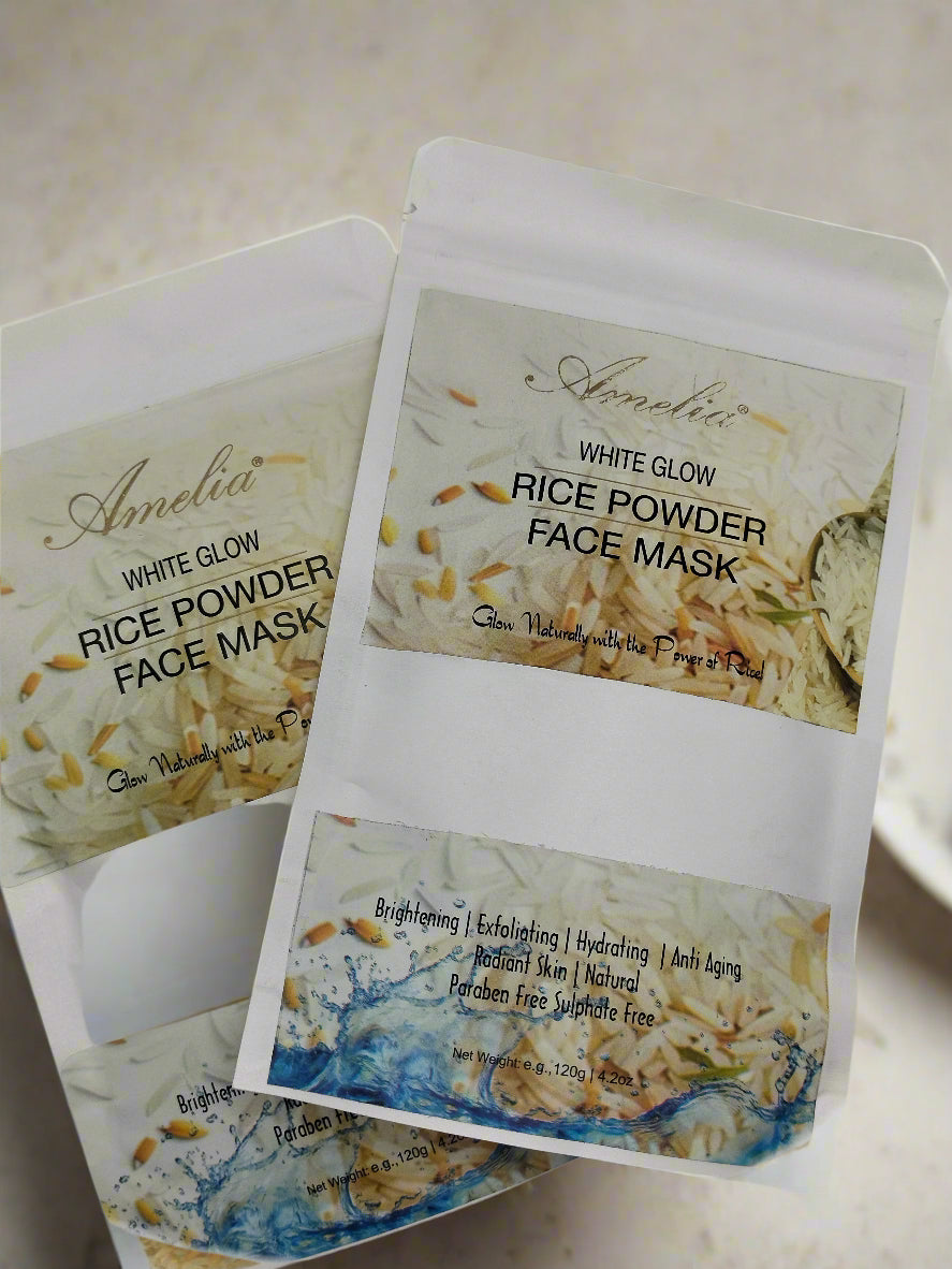 Amelia White Glow Rice Powder Face Mask packaging with a wooden spoon containing rice powder on a gray background